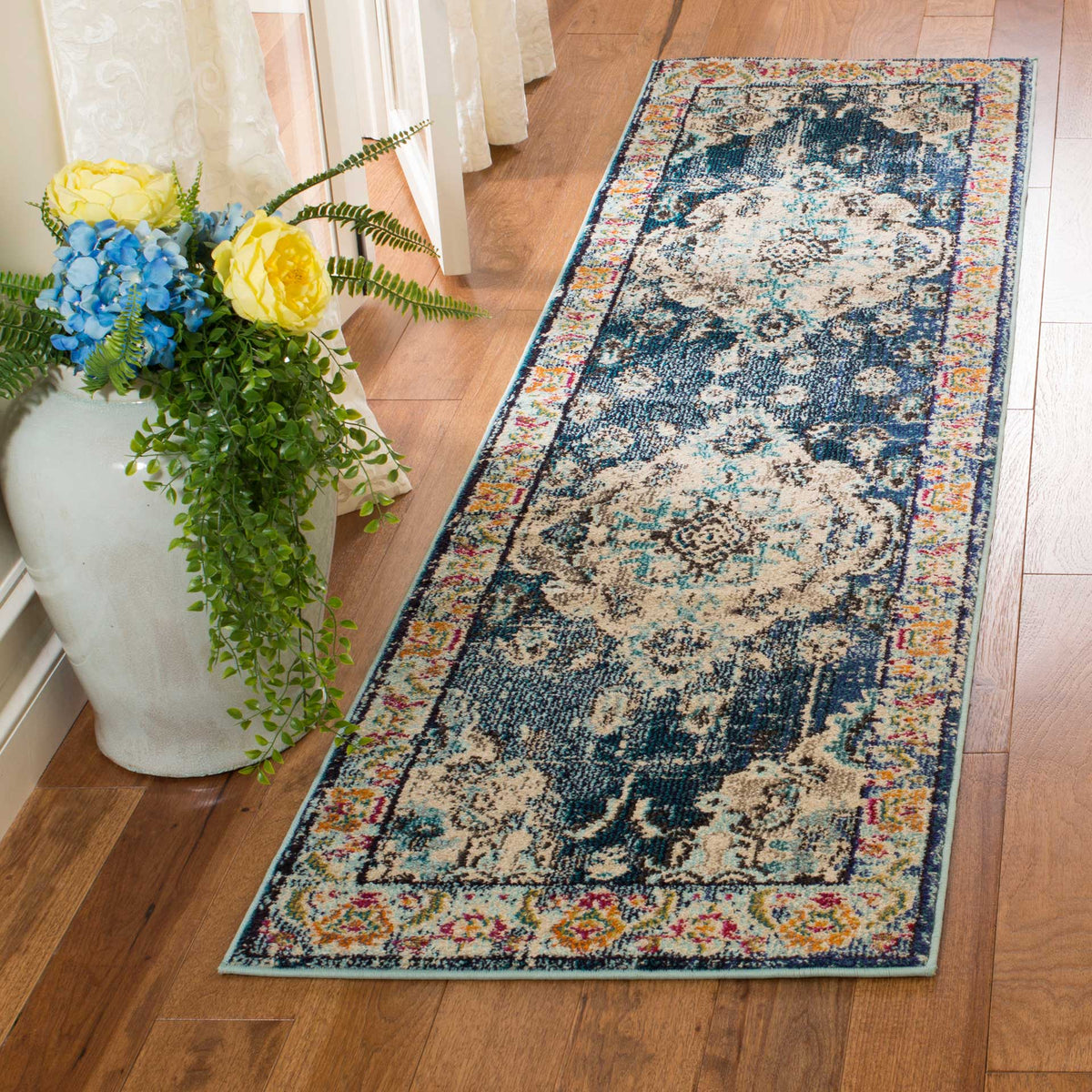 Navy and light blue runner lends classic medallion detail to a sunlit wood floor
