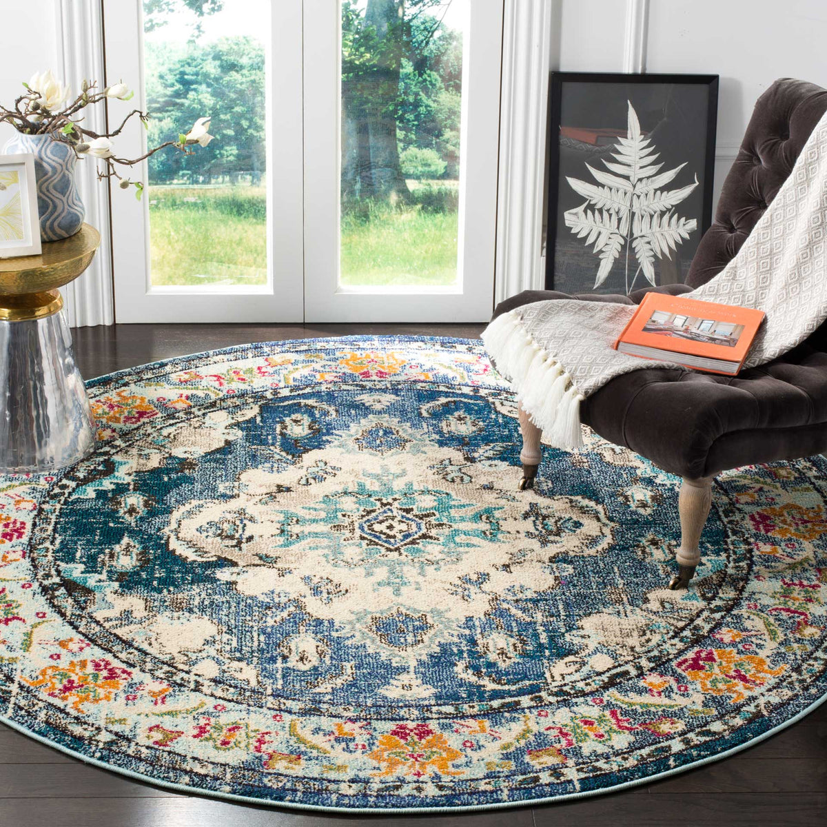 A cream medallion with pale blue accents stands out against navy, ringed by a colorful floral border