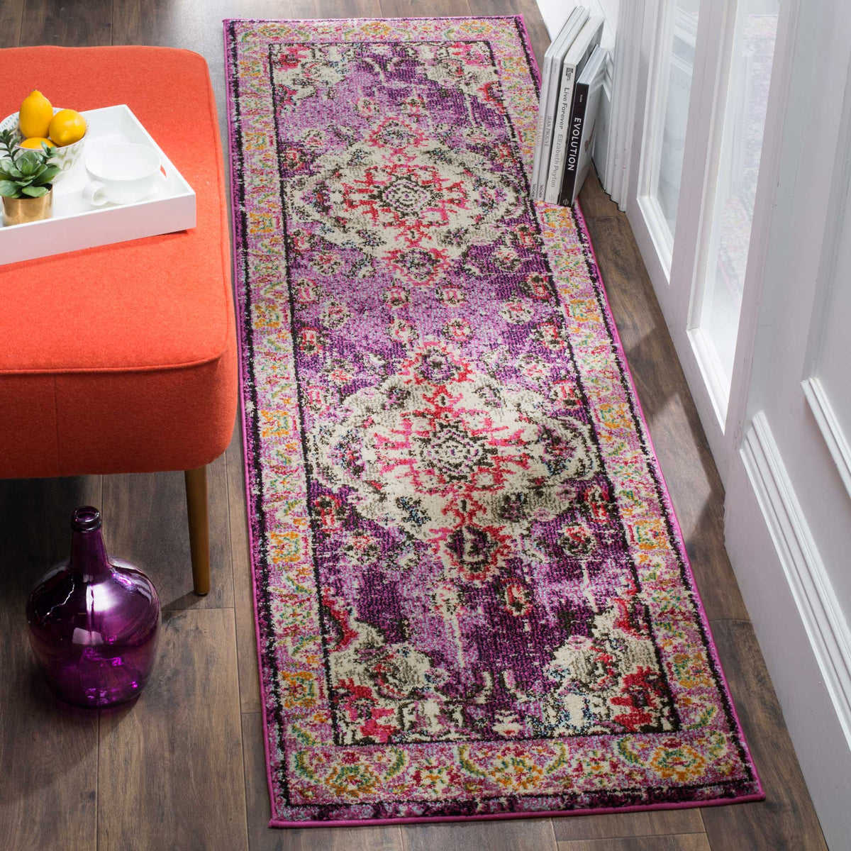 Violet and fuchsia runner brings ornate color to a walkway beside a coral upholstered seat