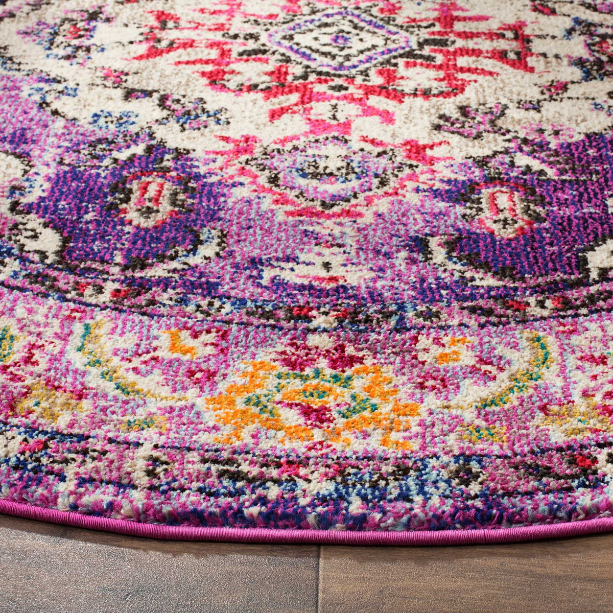 Purple and hot pink motifs meet orange flowers and a neatly bound edge on this textured rug