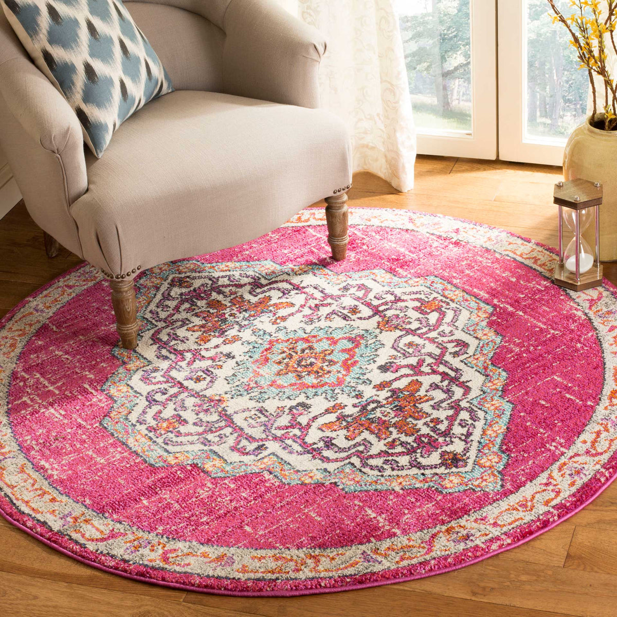 A bold pink field frames the ornate cream medallion, adding a lively accent to a wood floor.