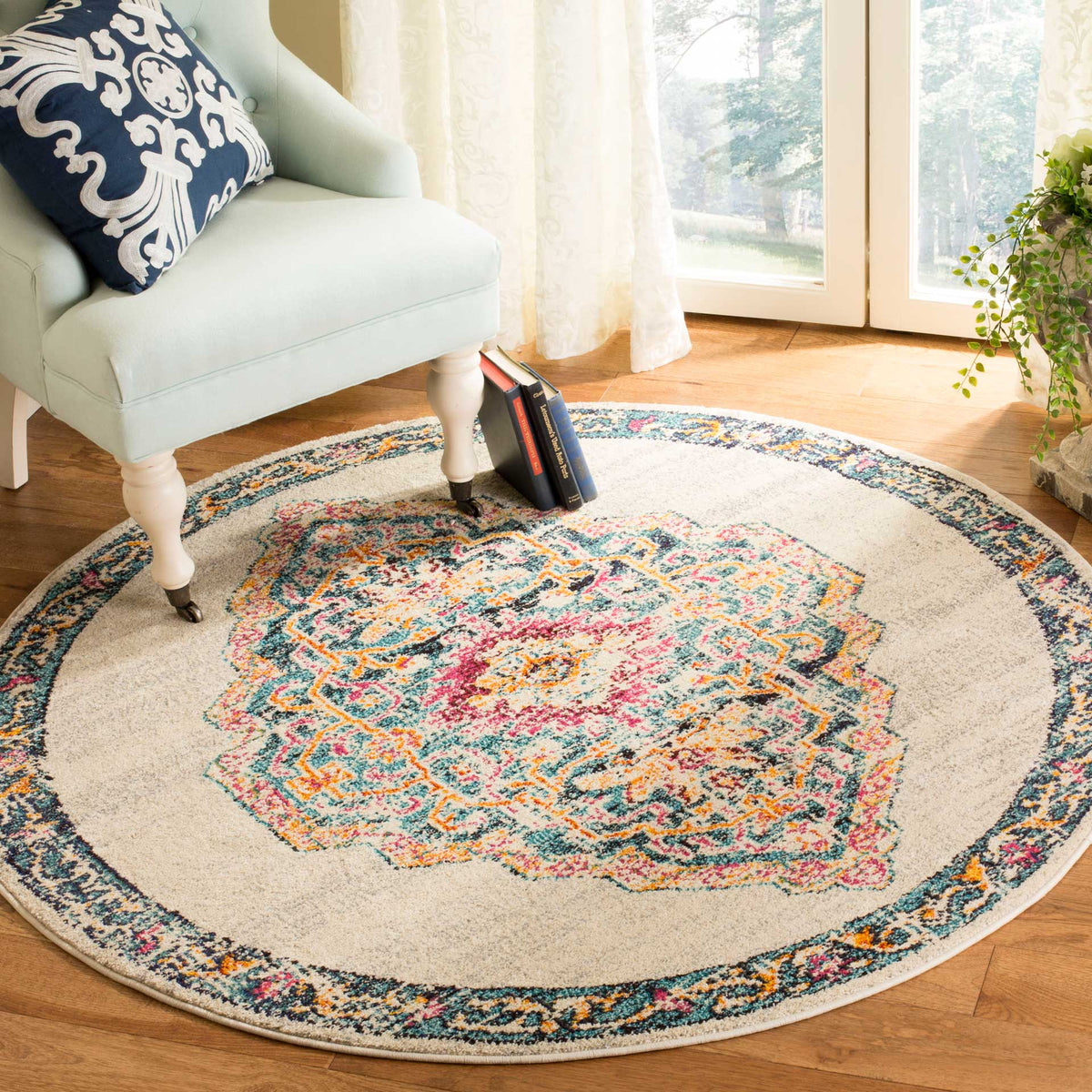 A vivid multicolor medallion brightens the cream field of this round rug beneath a pale chair.