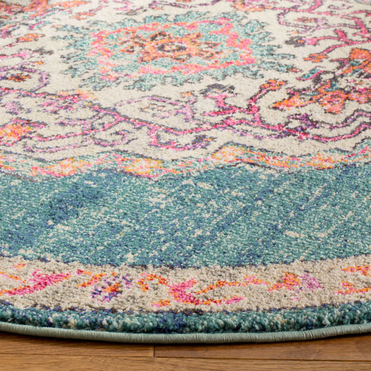 A textured teal-blue field meets a cream floral border and neatly bound edge.