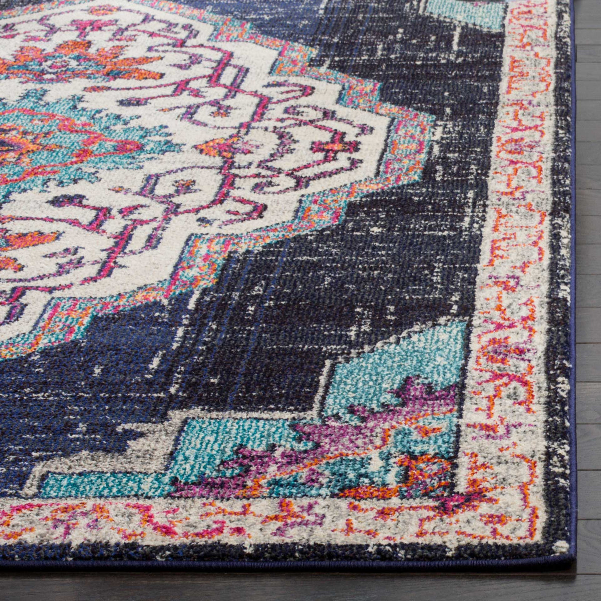 A cream floral border and turquoise accents contrast with the dark blue field and bound edge.