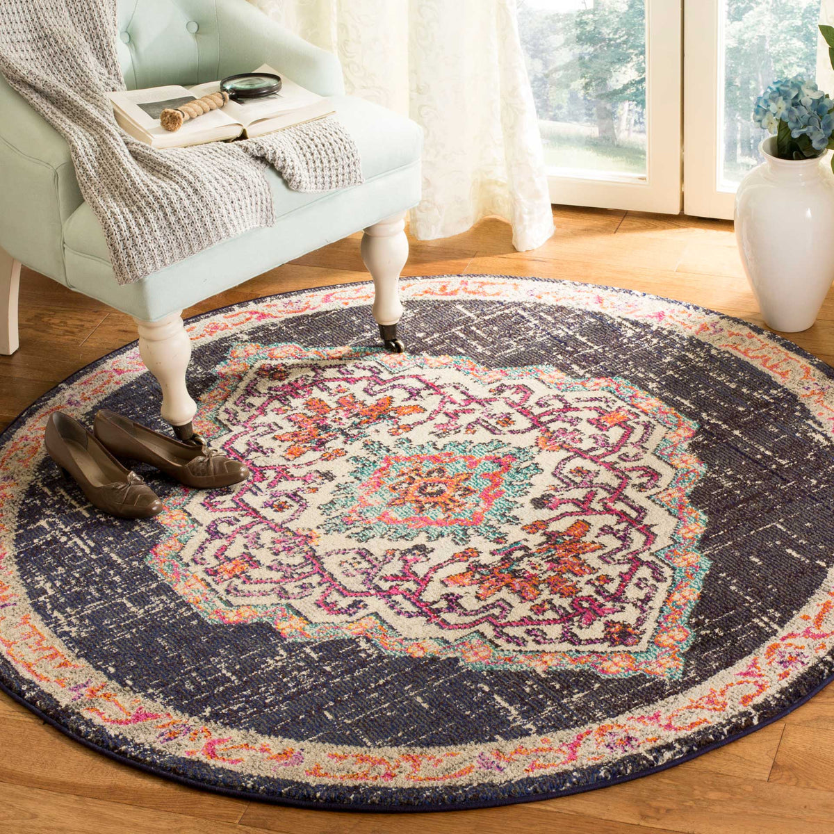 A dark, distressed field surrounds an ornate cream medallion for a striking accent on a wood floor.