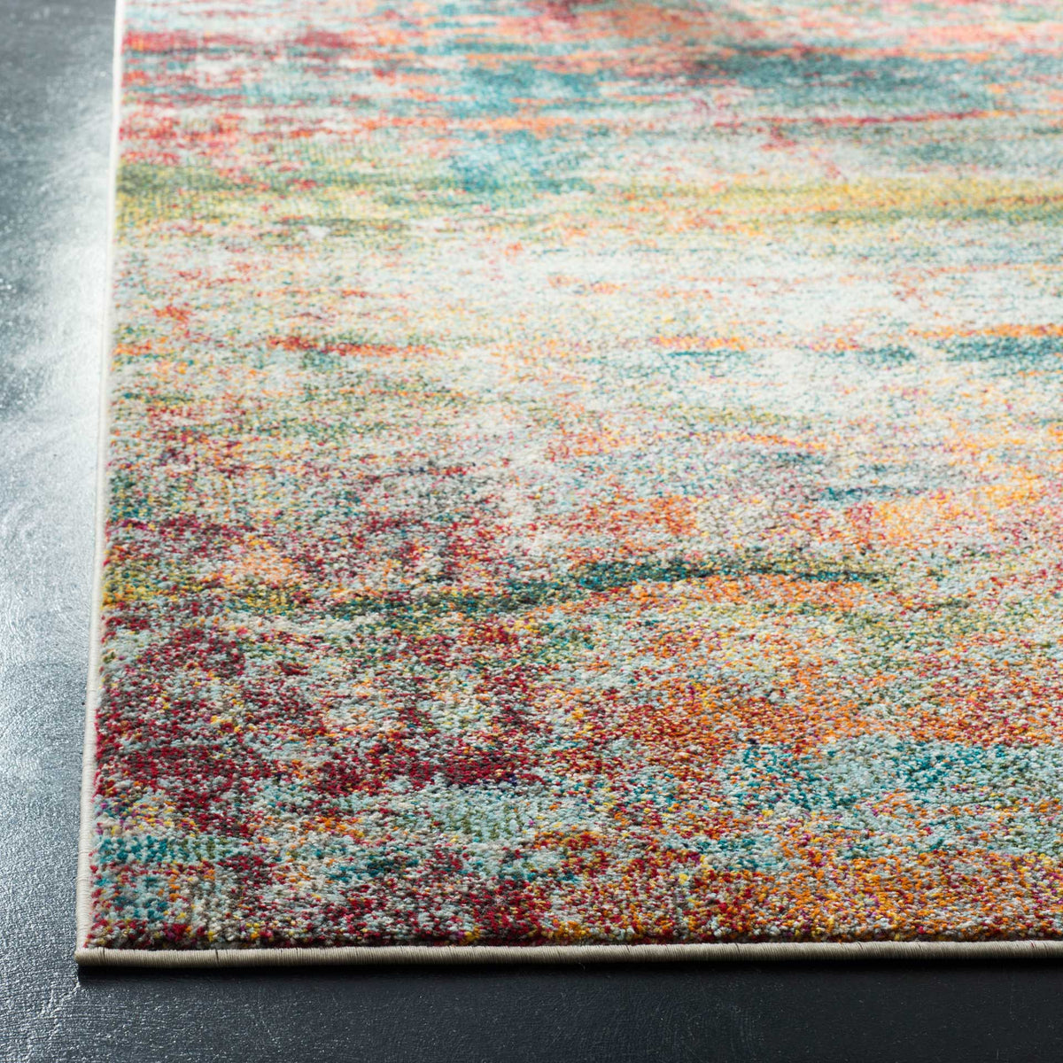 A neatly finished corner frames textured fibers in teal, orange, and red