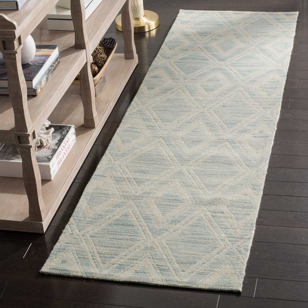 Soft blue and ivory diamond-pattern runner adds color and texture to dark wood floors