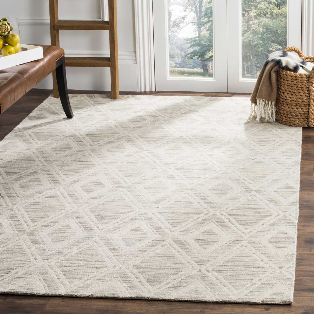 A light brown and ivory diamond rug brings gentle pattern and warmth to a bright space with wood floors.