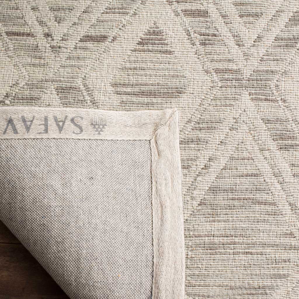 A woven fabric backing and bound edges add a finished touch to the light brown and ivory rug.