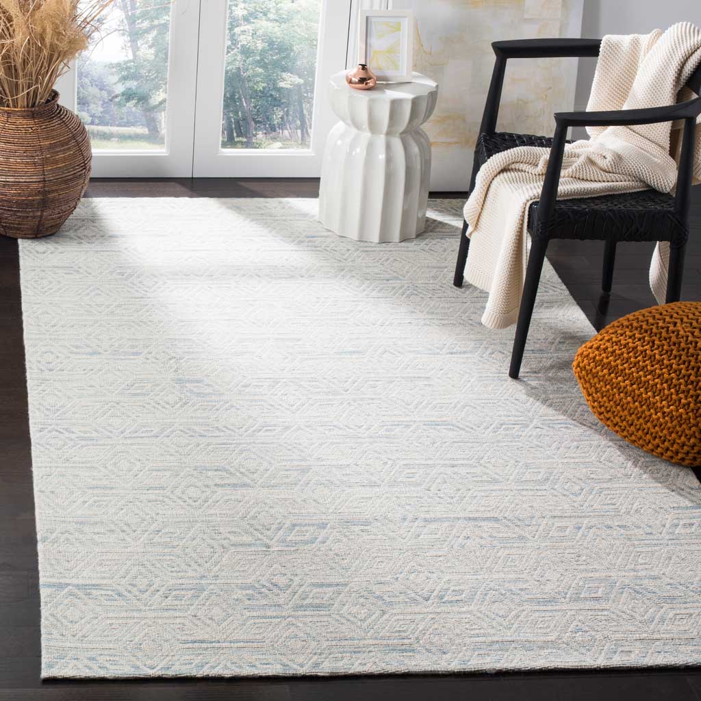 Soft blue geometric motifs bring a serene touch to an ivory wool rug in a bright living space
