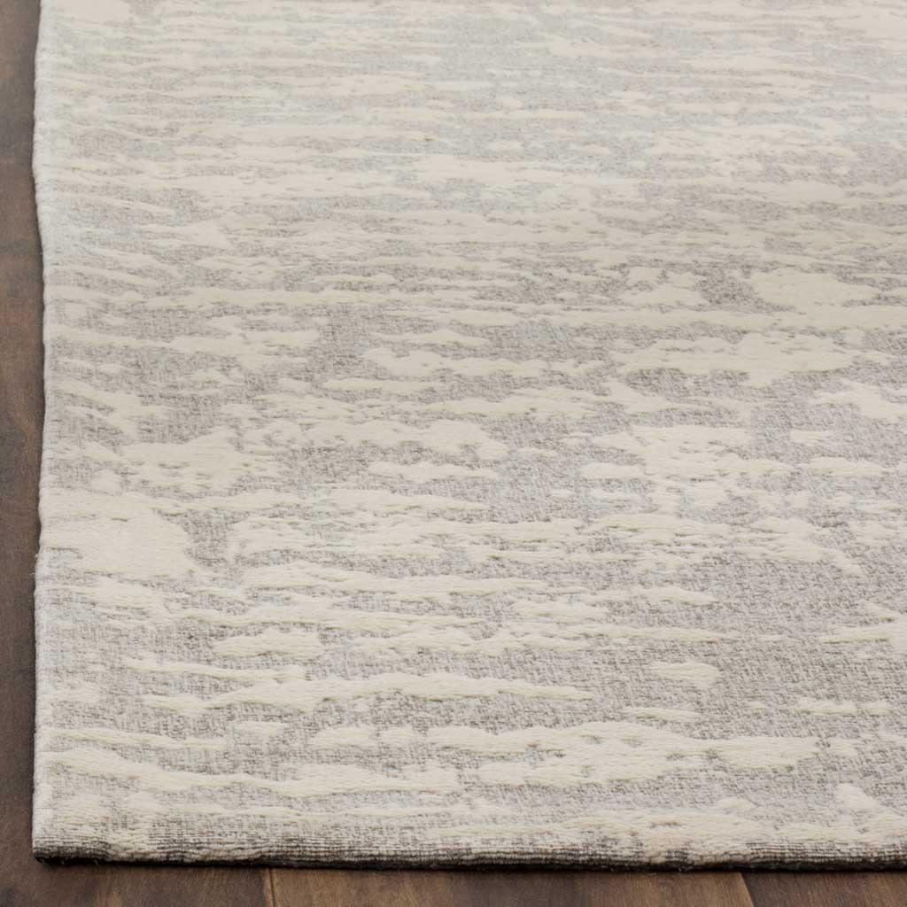 Soft ivory and gray striations reveal the rug's woven texture and neatly finished edges.