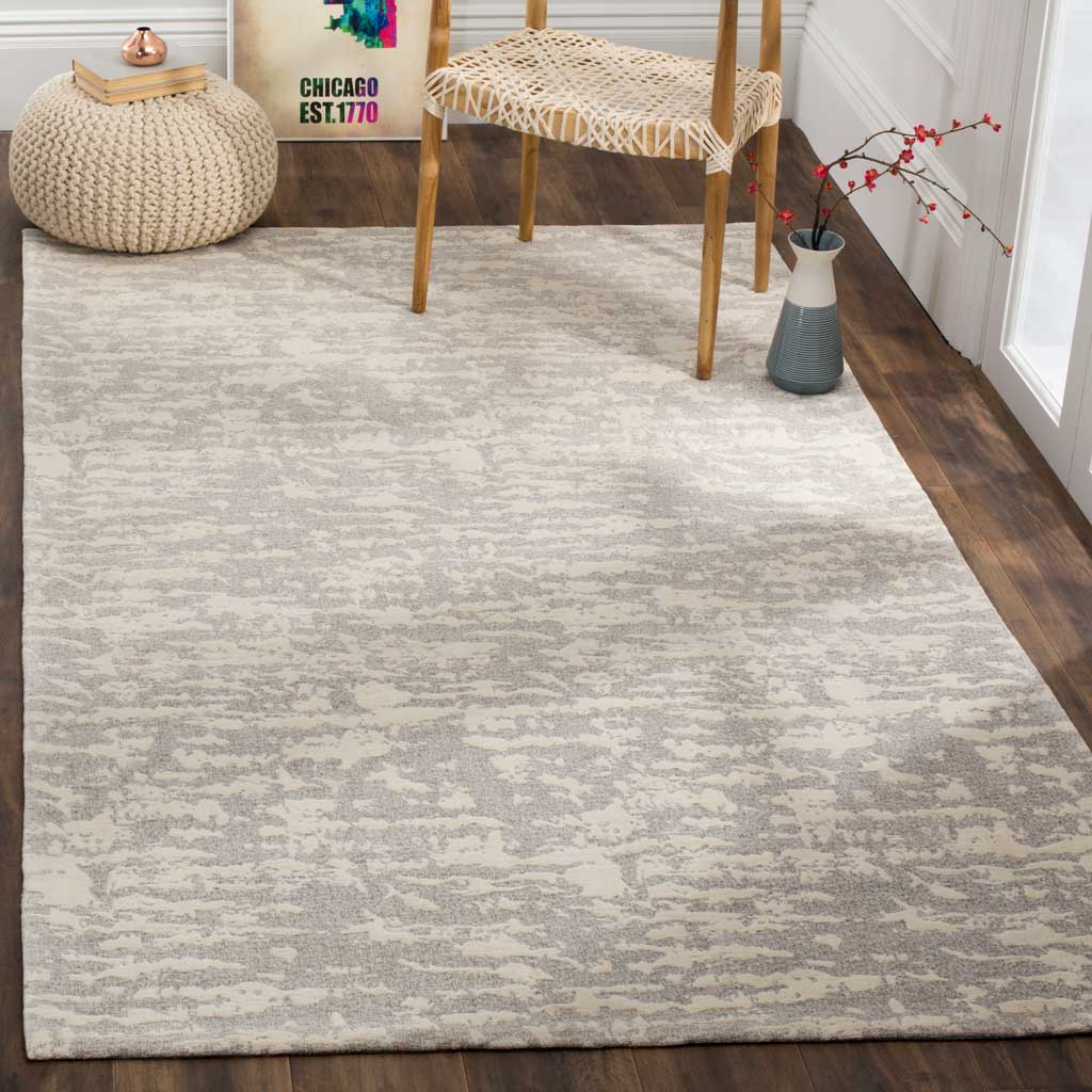 Light gray and ivory pattern brings a calm, textured foundation to the furnished space.
