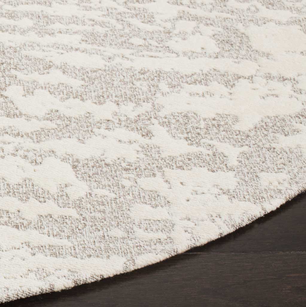 Ivory accents stand out against a light gray ground with subtle raised texture