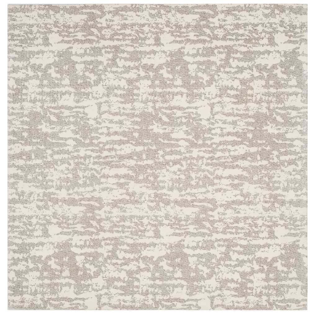 Square light gray and ivory rug pairs irregular bands with a gentle, understated palette.