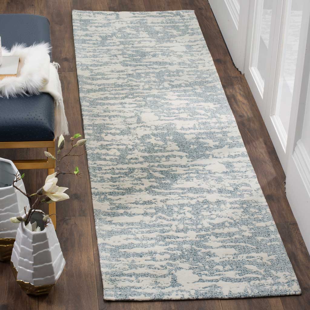 Soft blue and ivory tones give this patterned runner a serene hallway accent