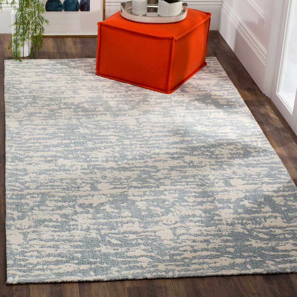 Blue and ivory abstract pattern grounds the space with a relaxed, contemporary feel.