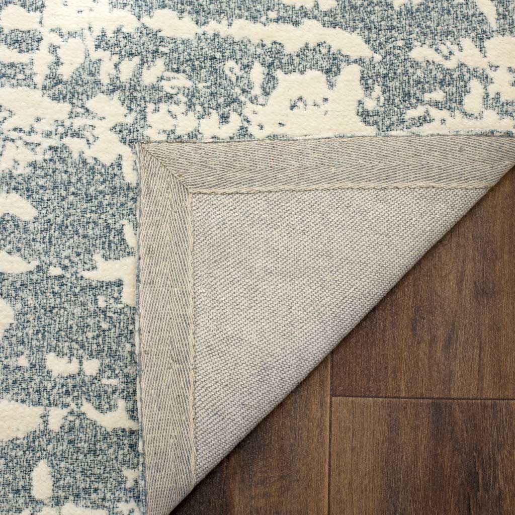 A tightly woven underside and bound edge give this blue and ivory rug a tidy finish.