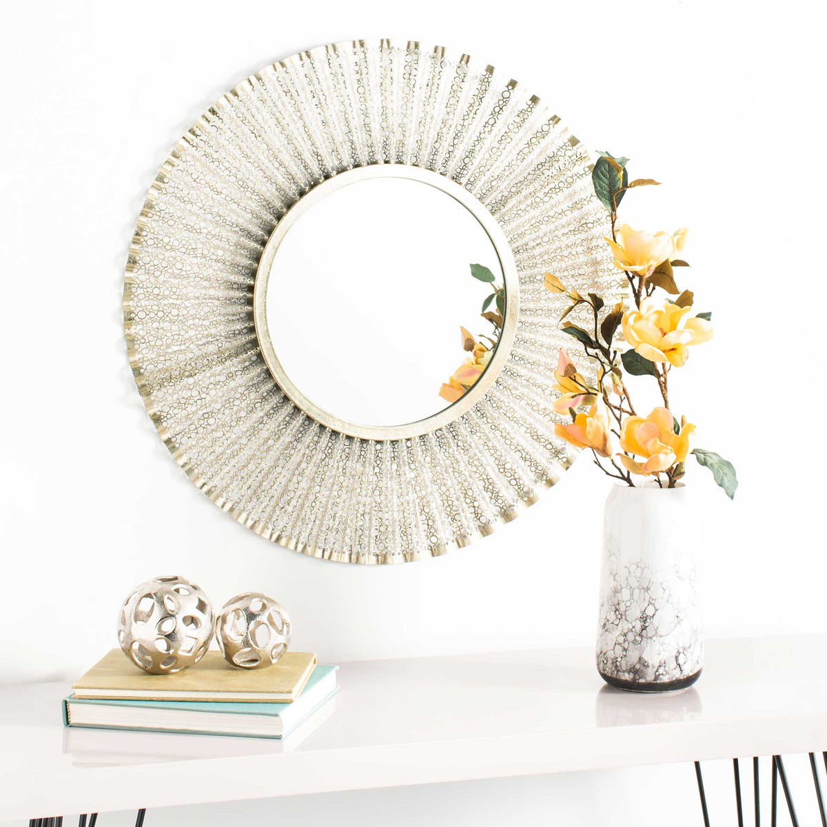 A gold openwork mirror brings warmth and delicate texture to a bright interior