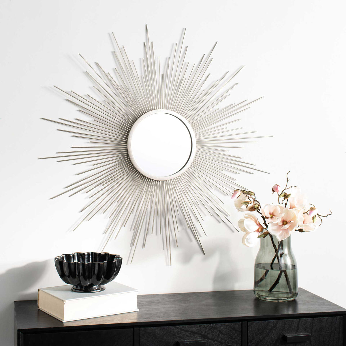 Champagne sunburst mirror adds a sculptural accent above a console