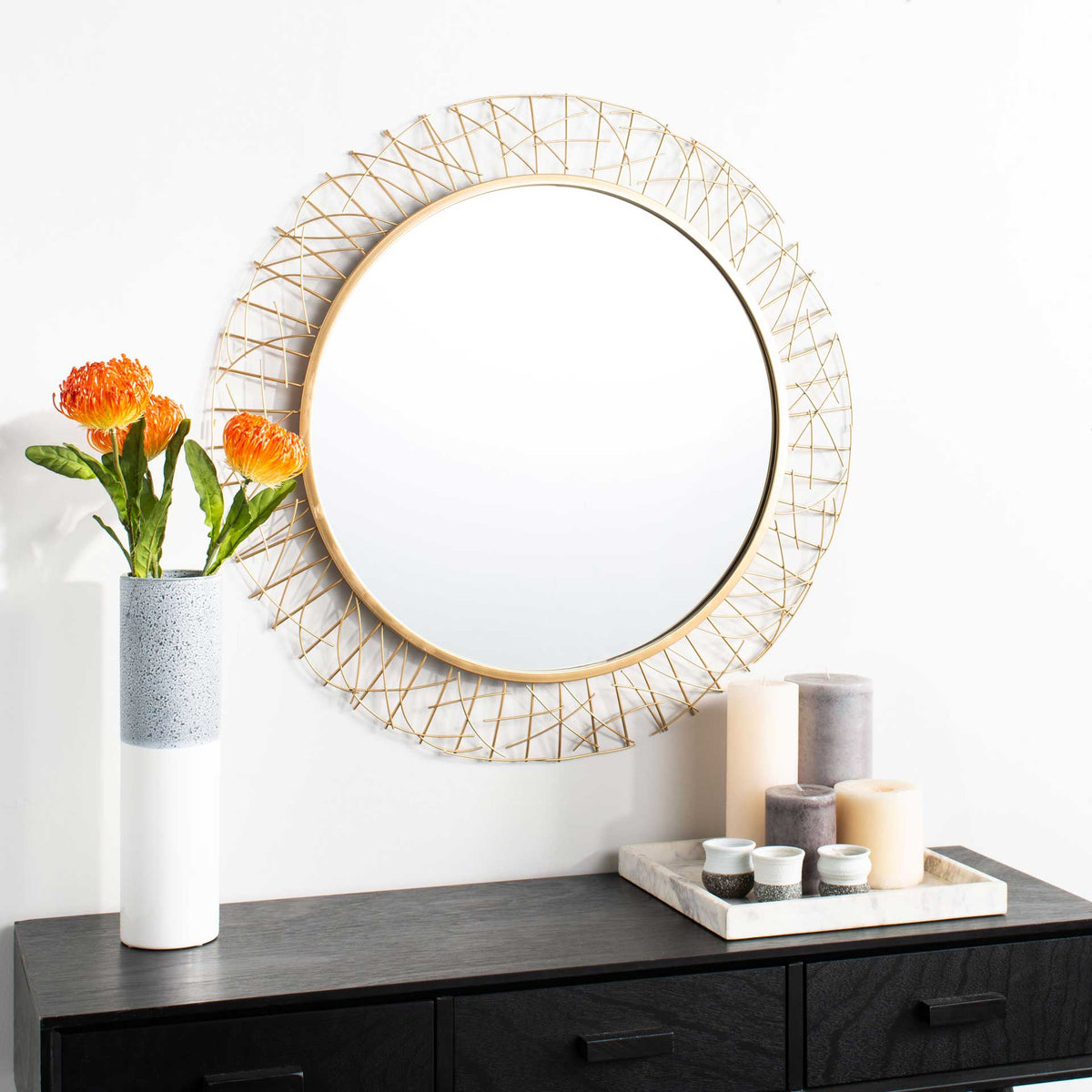 Gold openwork mirror adds a sculptural accent above a dark console