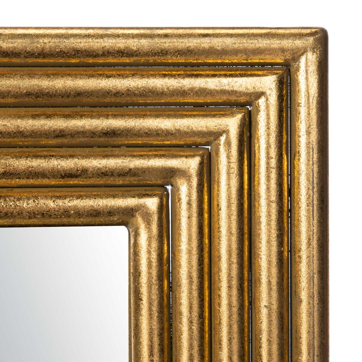 Textured gold molding layers around the mirror's crisp inner edge.