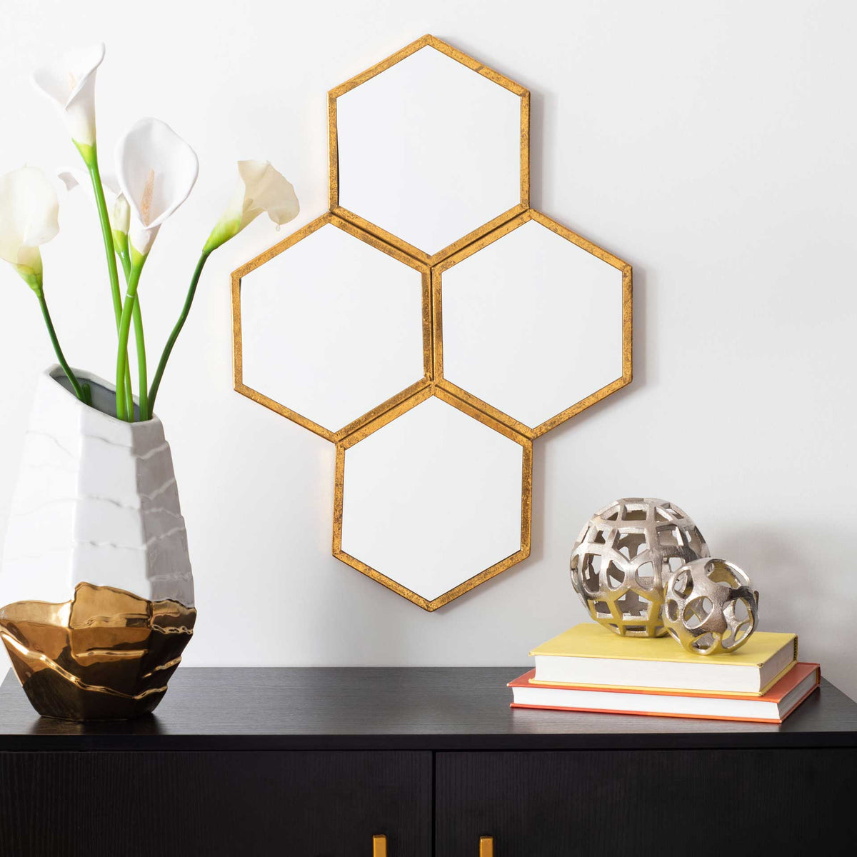 A cluster of gold-framed hexagonal mirrors creates a geometric wall accent