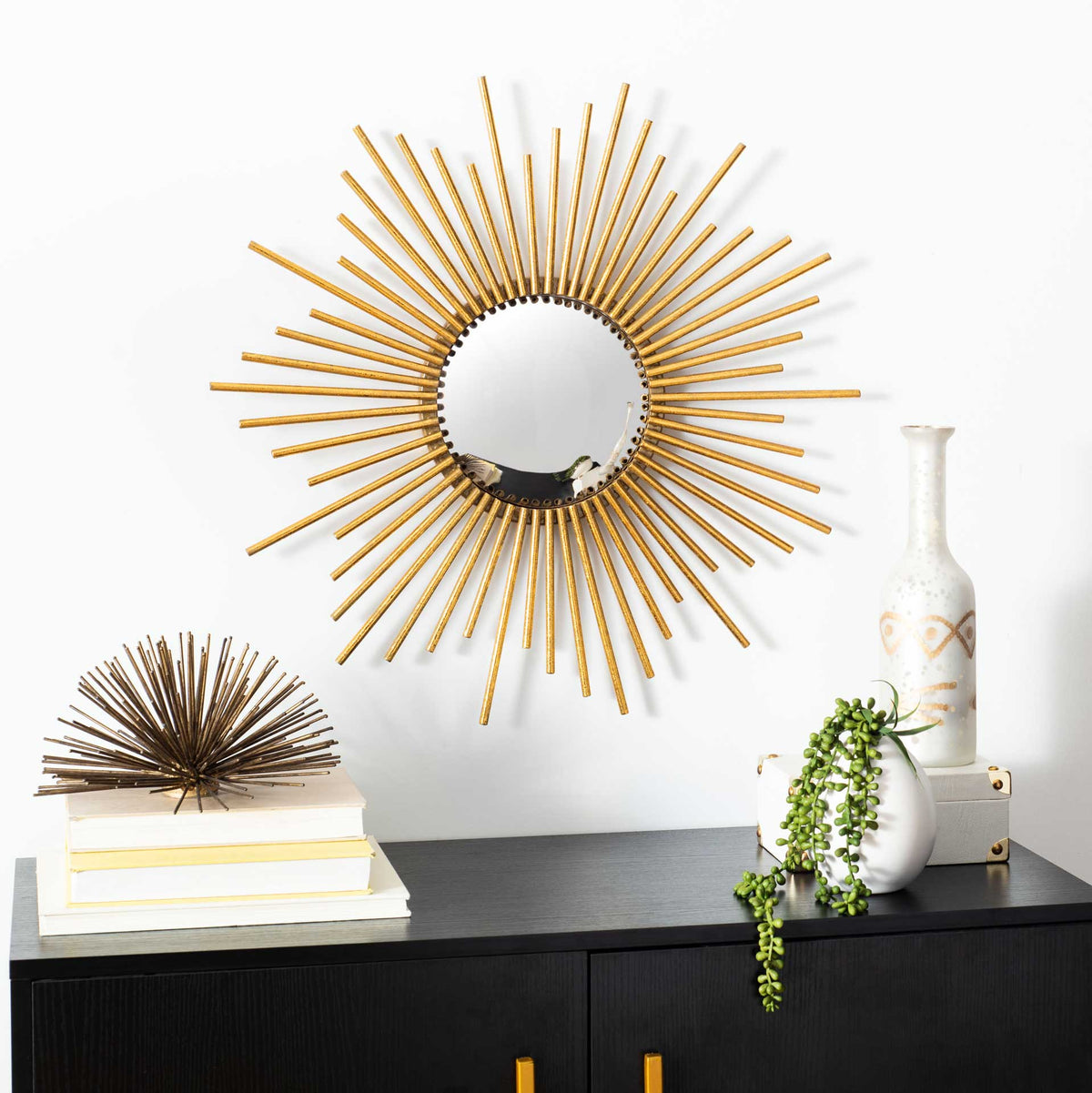 Golden sunburst rays make this circular mirror a radiant focal point above a console