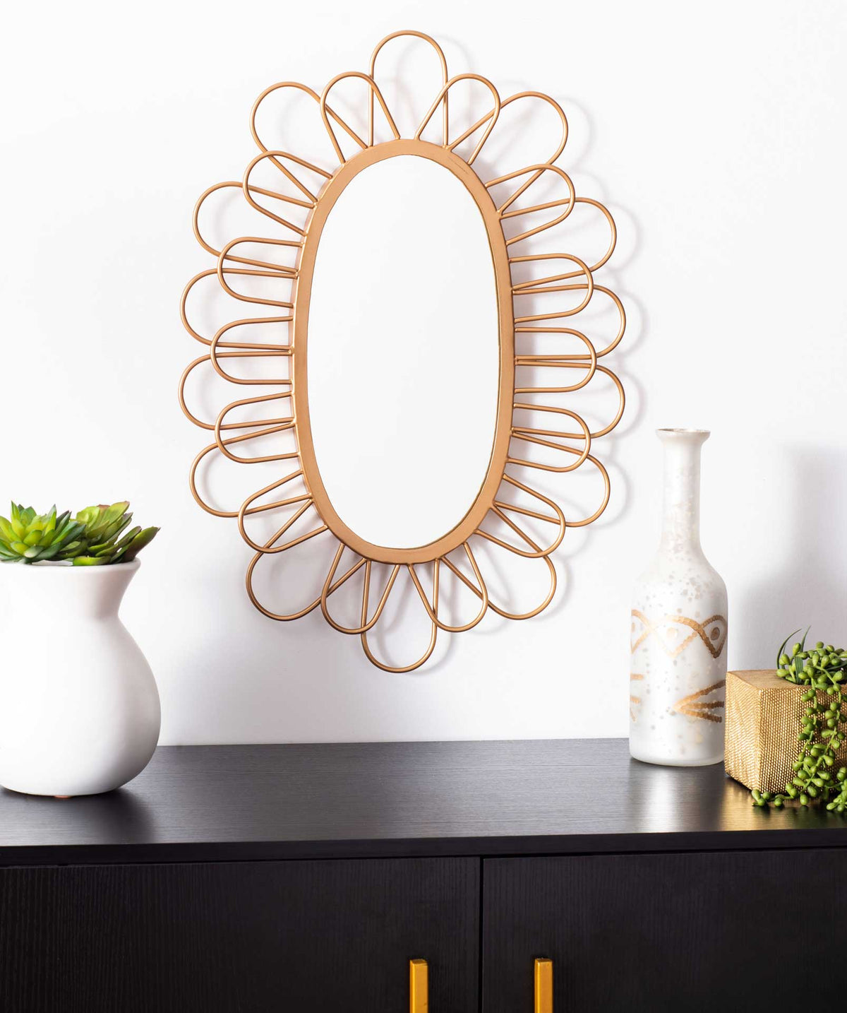 Gold wall mirror with an airy, flower-like frame that adds a sculptural accent