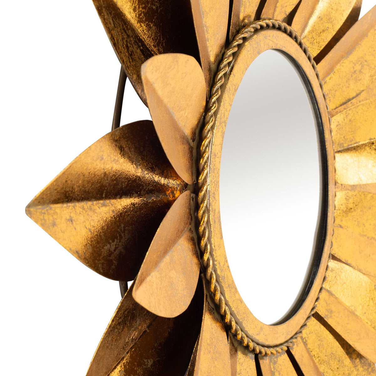 Sculptural gold petals and twisted trim lend rich texture to the mirror's rim