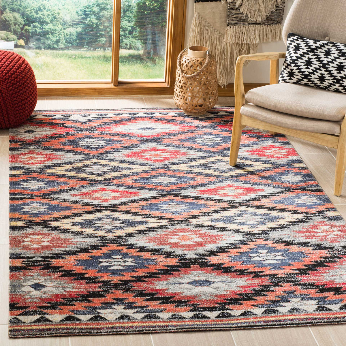 A colorful geometric rug brings warmth beneath a cushioned lounge chair
