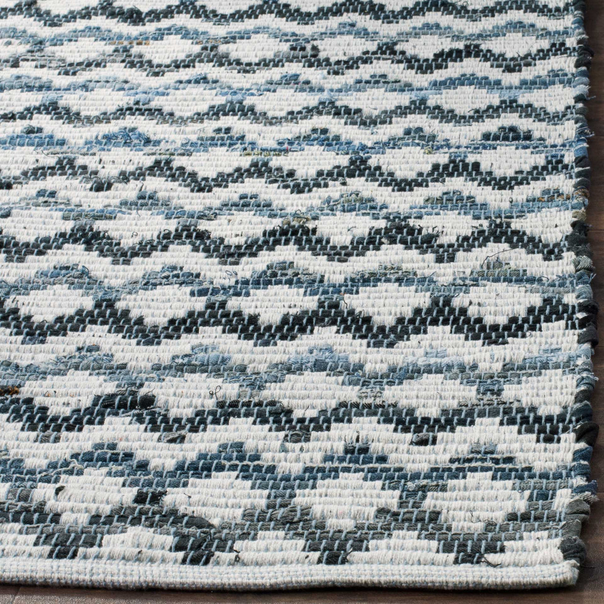 Ivory cotton weave and finished edges show fine blue and black undulating lines