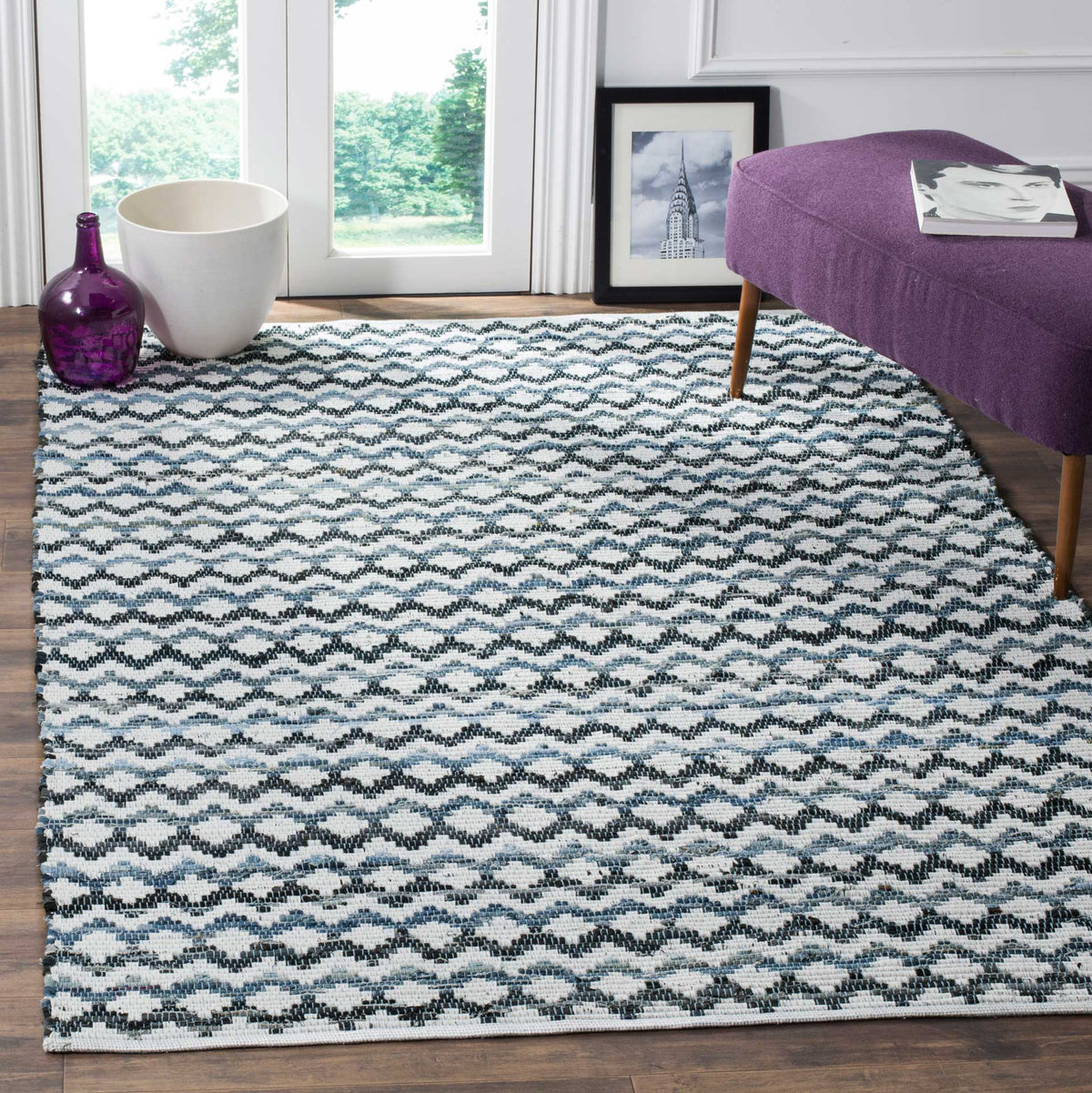 Ivory cotton rug with lively black and blue waves brightens a cozy sitting area