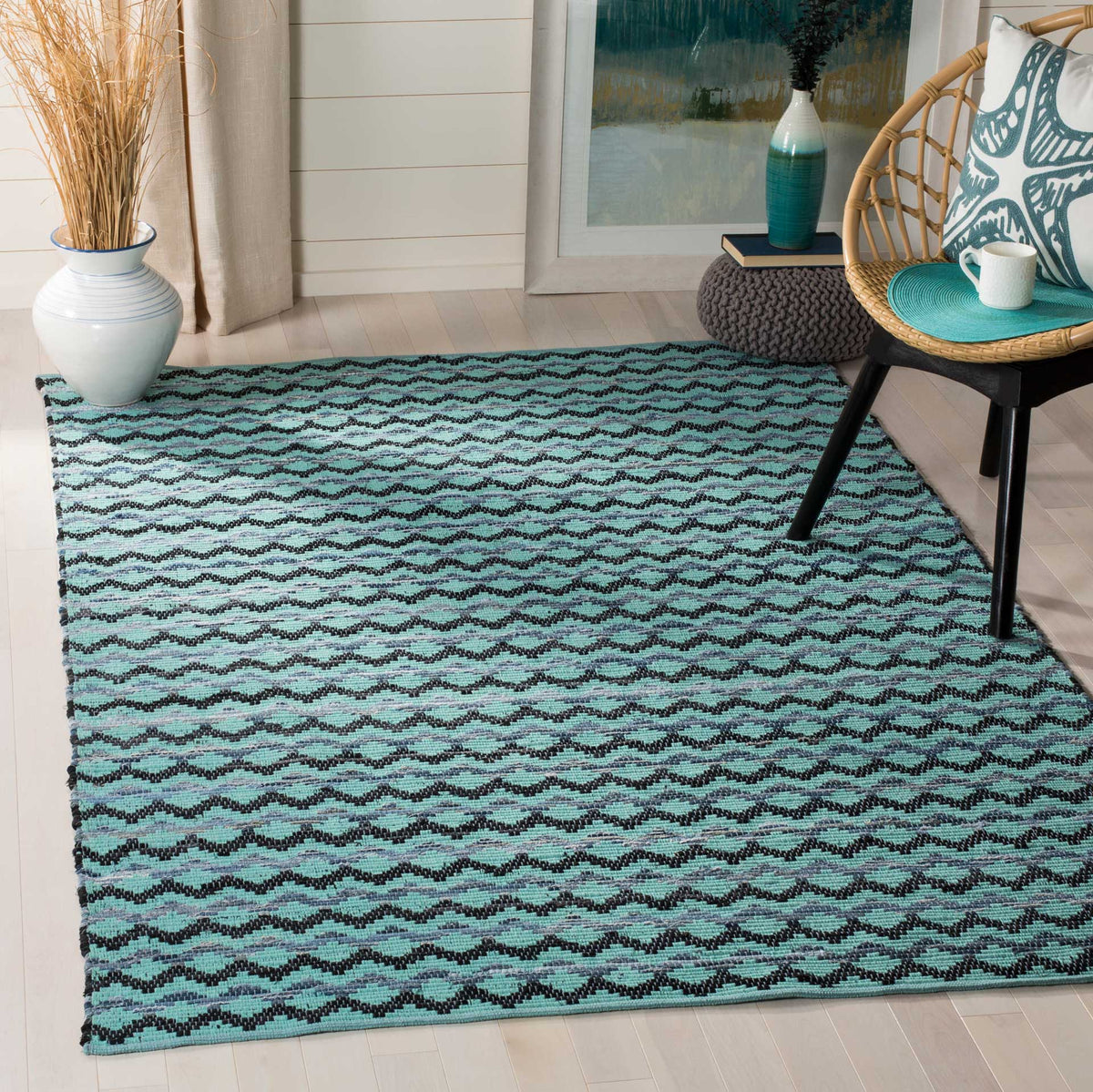 Turquoise cotton rug with flowing black wave bands adds lively texture to the floor