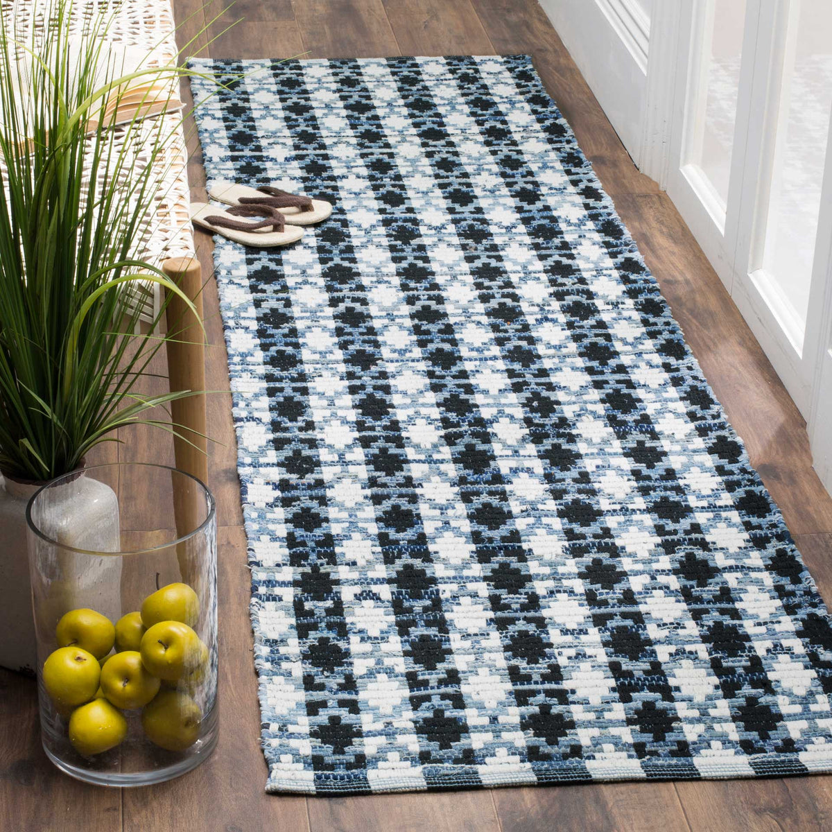 Black geometric markings and soft blue threads add dimension to this ivory handwoven runner.