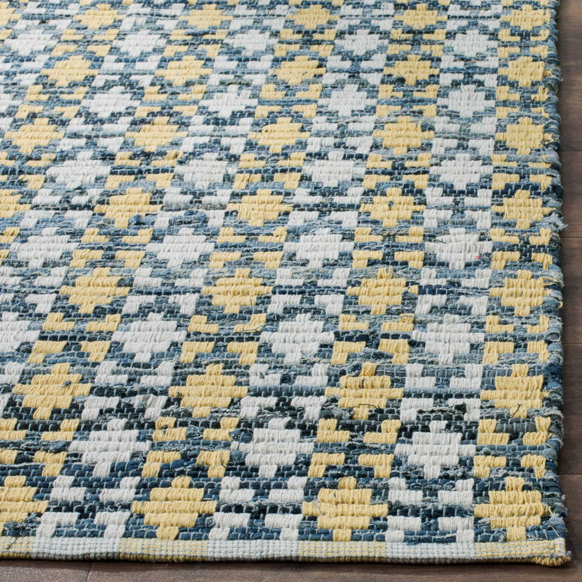 Dense gold and blue woven accents show off the textured cotton finish and bound edge