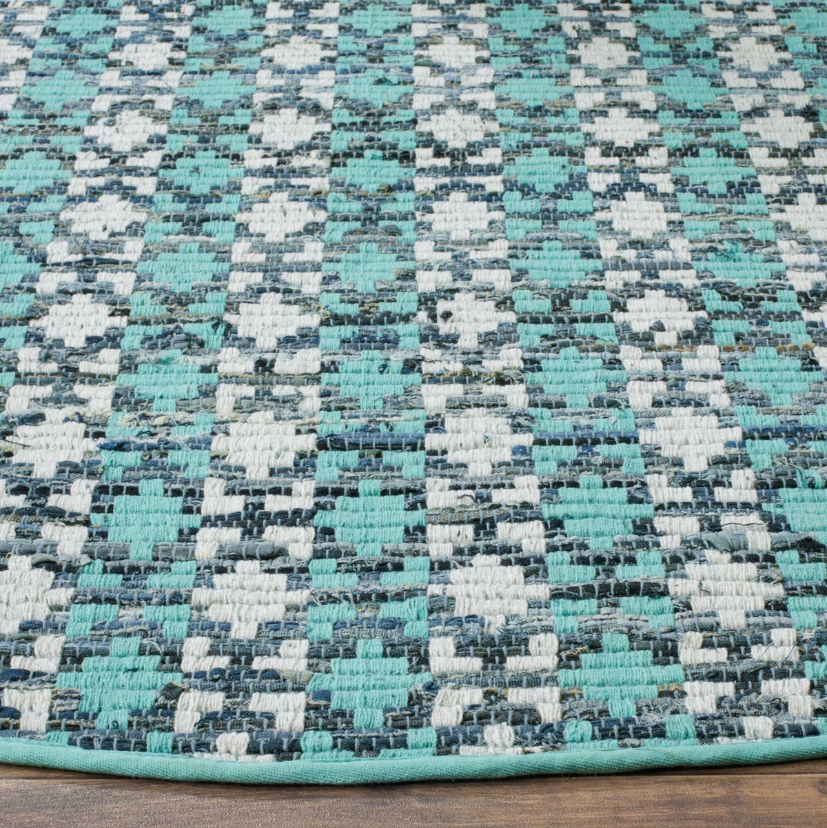 Turquoise and ivory woven motifs mingle with deep blue accents and a matching bound edge