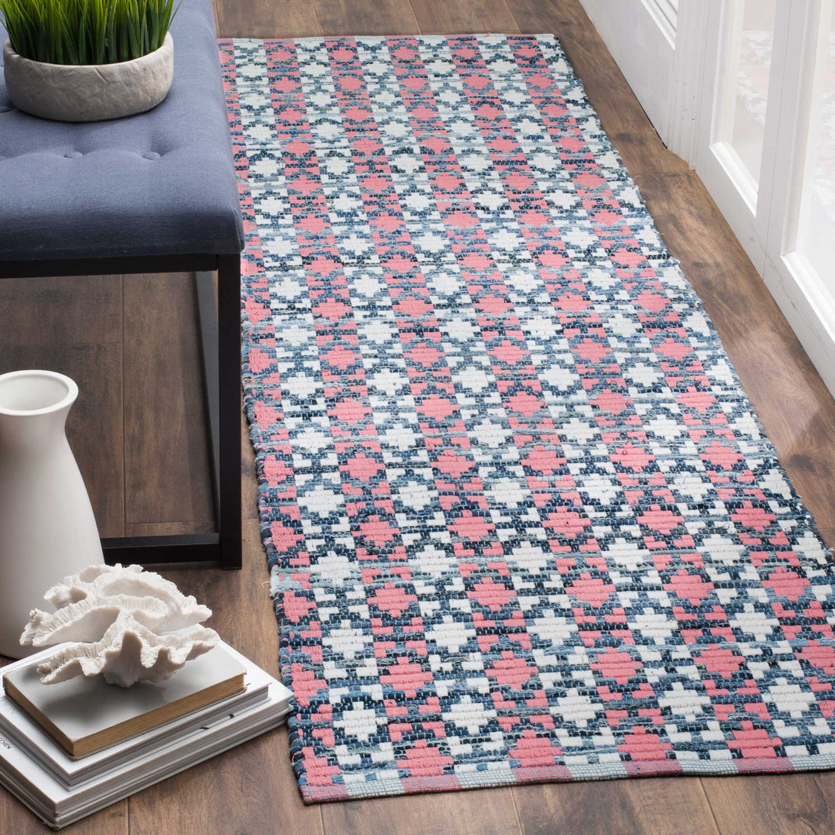 Coral accents dance among deep blue motifs on a colorful handwoven cotton runner.