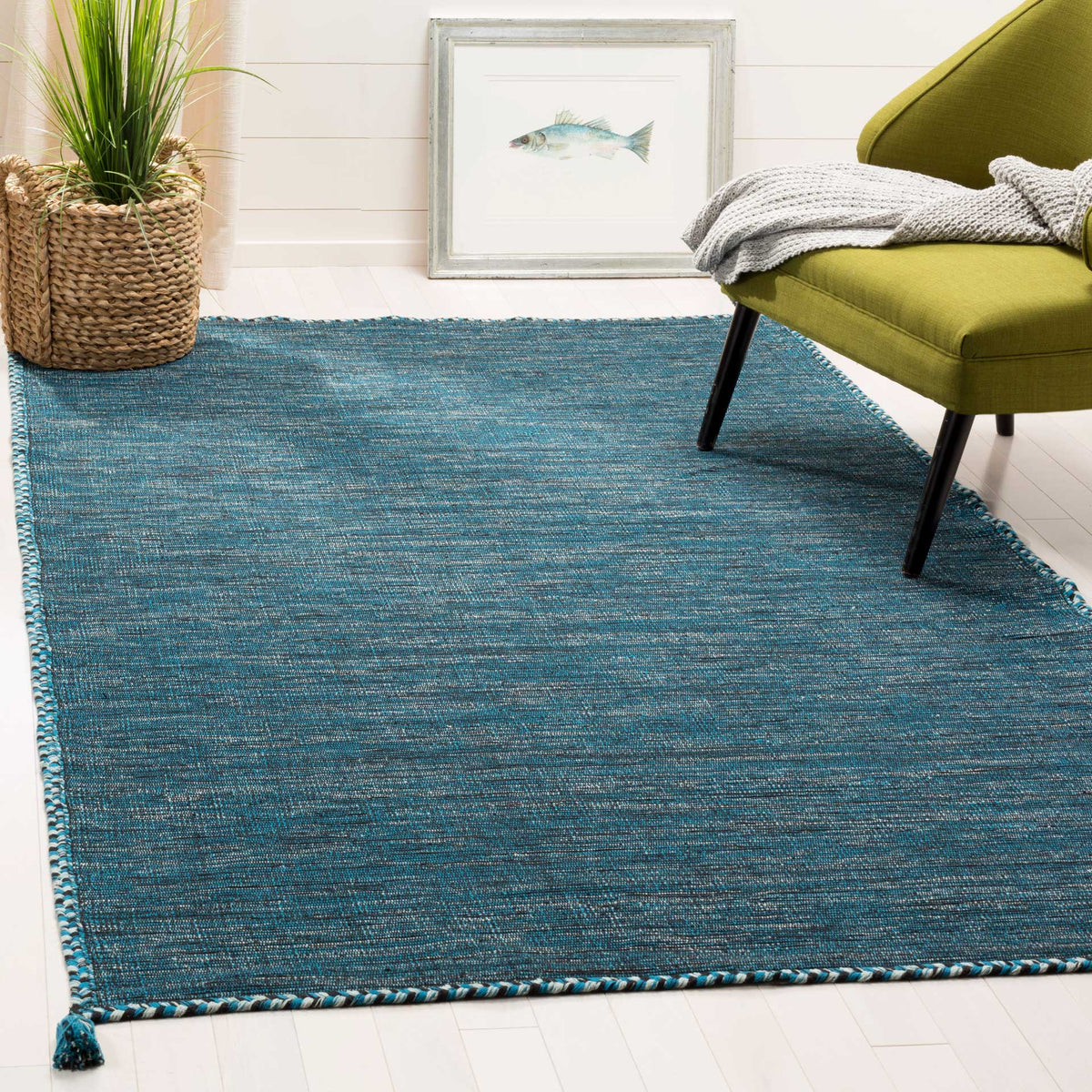 Deep blue and black cotton weave adds a vibrant, textured foundation beneath a lounge chair.
