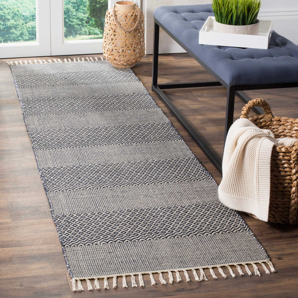 Deep navy zigzags and ivory stripes add lively pattern to this fringed cotton runner.
