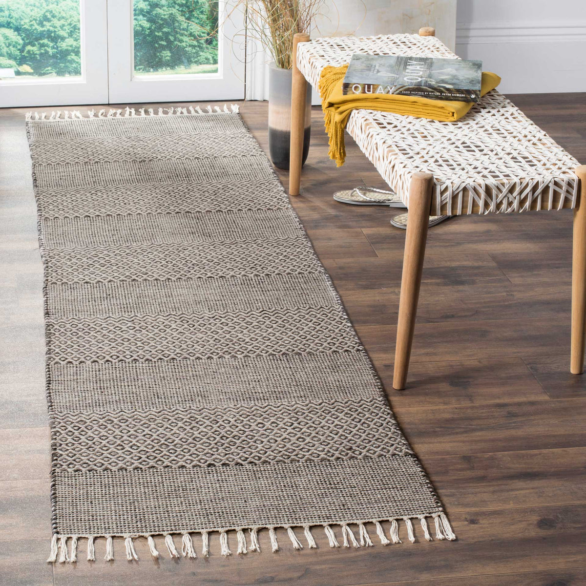 Alternating anthracite and ivory woven bands lend this fringed runner a relaxed, textured look.