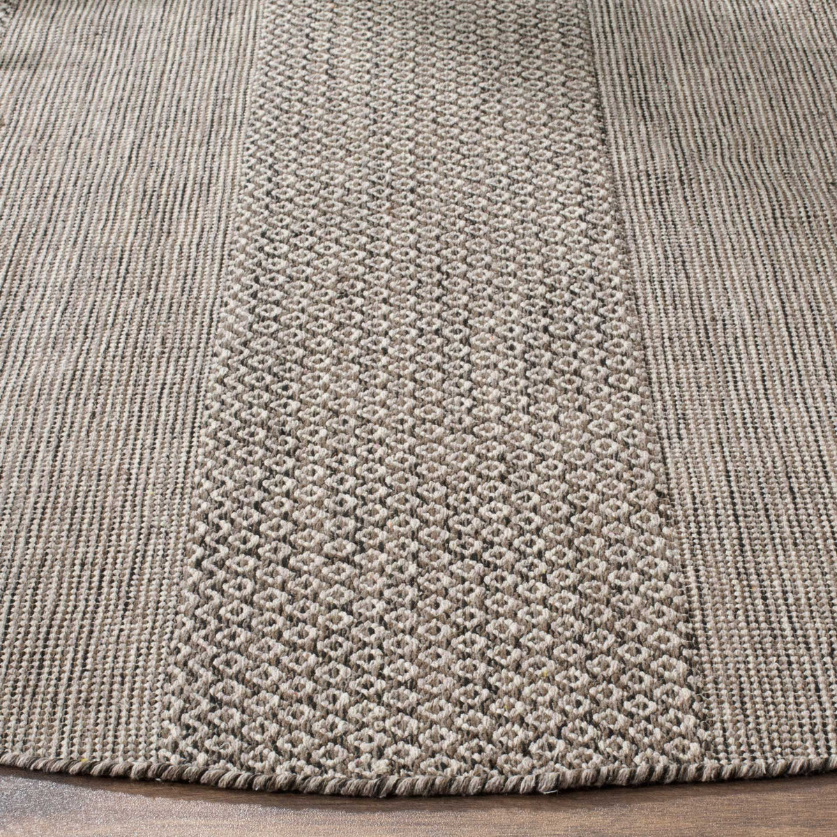 Textured cotton weave and anthracite diamonds meet at the rug's neatly finished edge