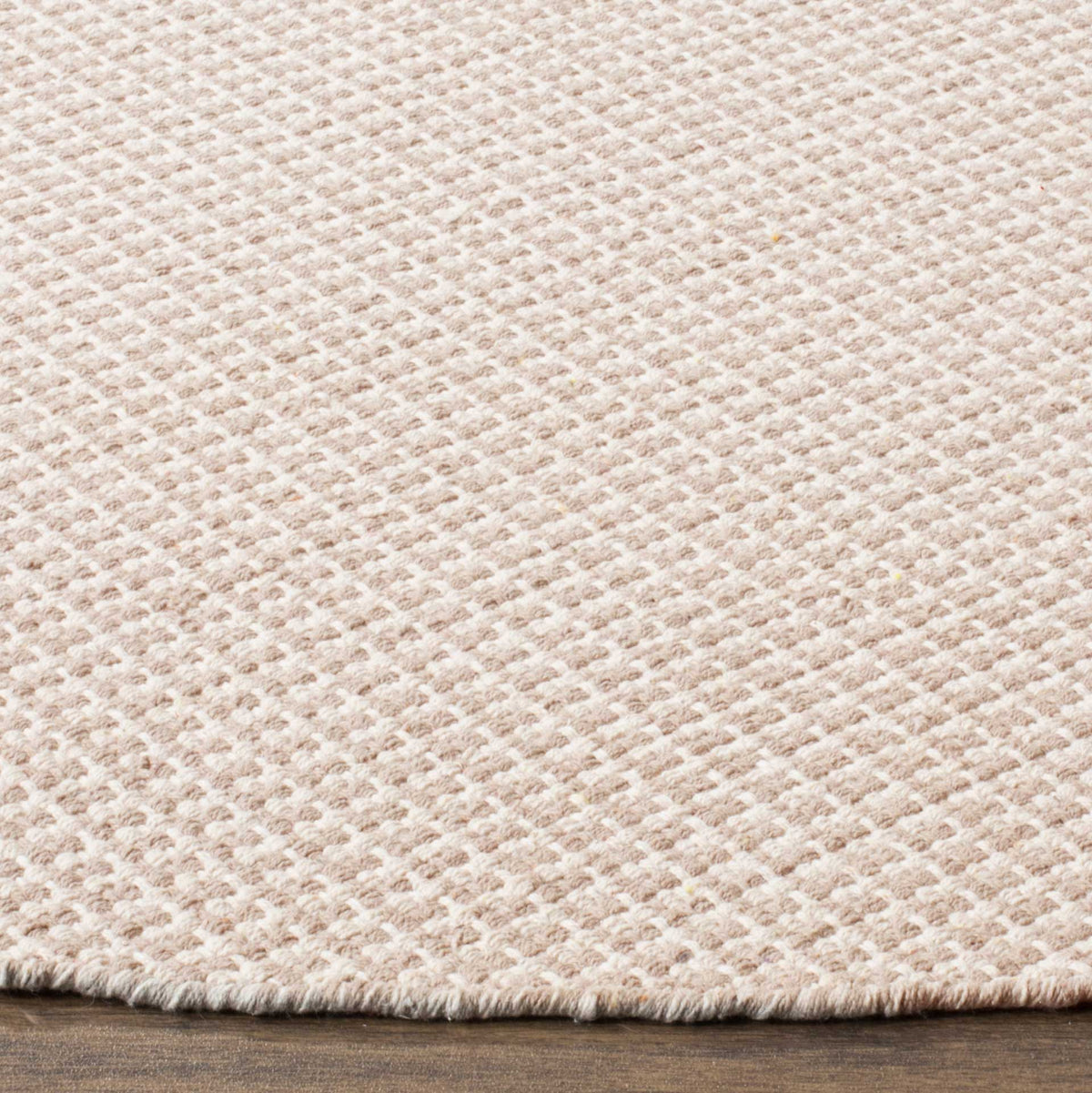 Soft ivory and gray cotton yarns form a fine raised weave along a finished edge