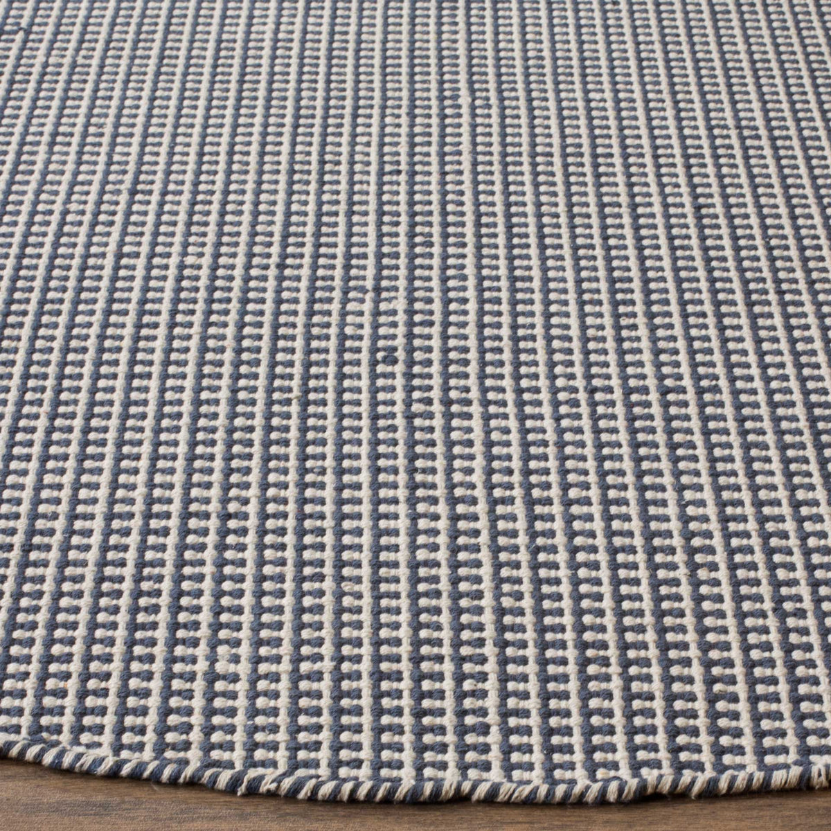 Navy and ivory woven rows create a crisp, textured surface and finished edge