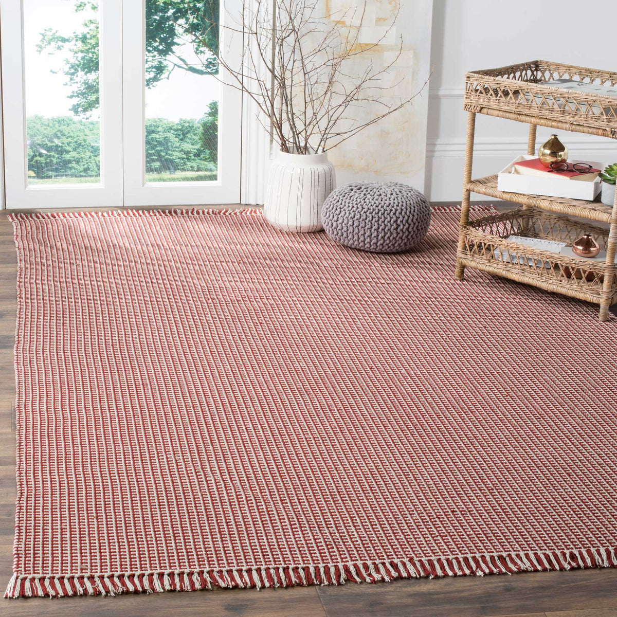 Red and ivory woven cotton rug enlivens a sunny room with graphic texture and fringe
