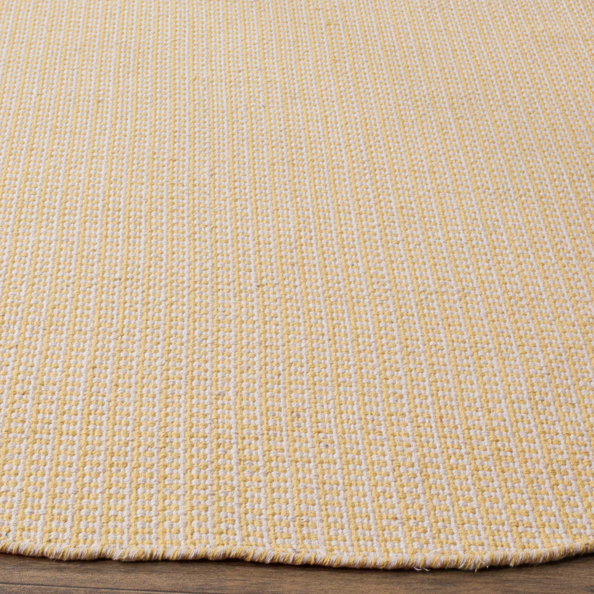 Yellow and ivory yarns interlace in textured rows along a neat woven edge