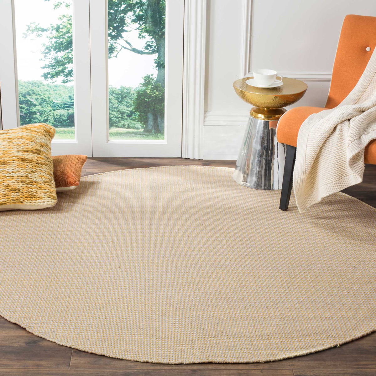 Warm yellow and ivory round rug softens a living space with fine woven texture