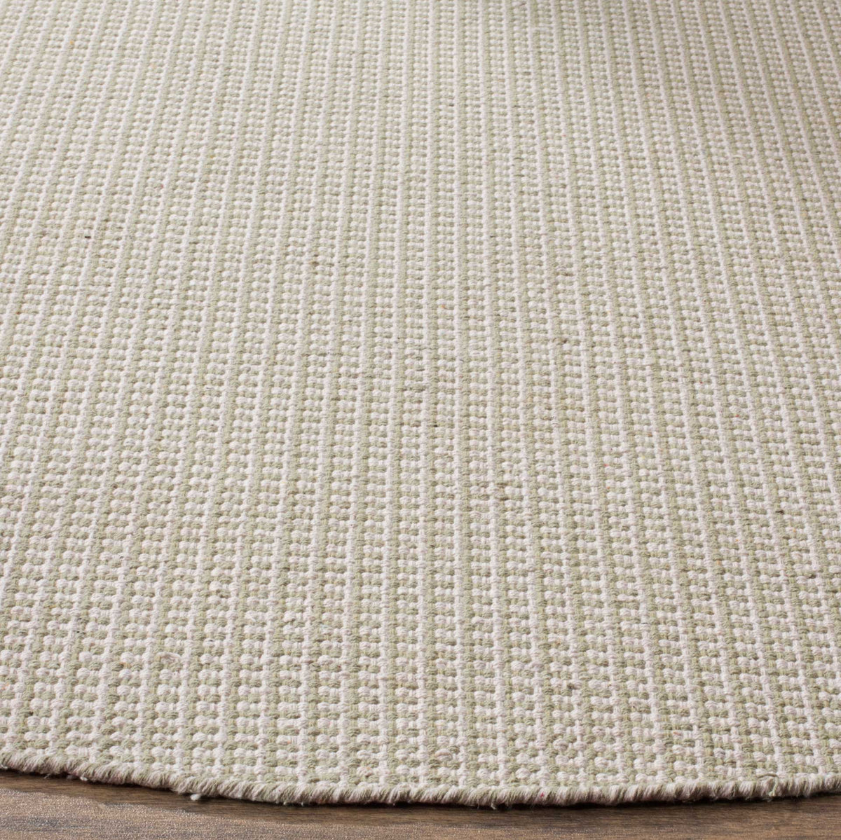 Fine ivory and pale green yarns form a dense weave with a neatly finished edge