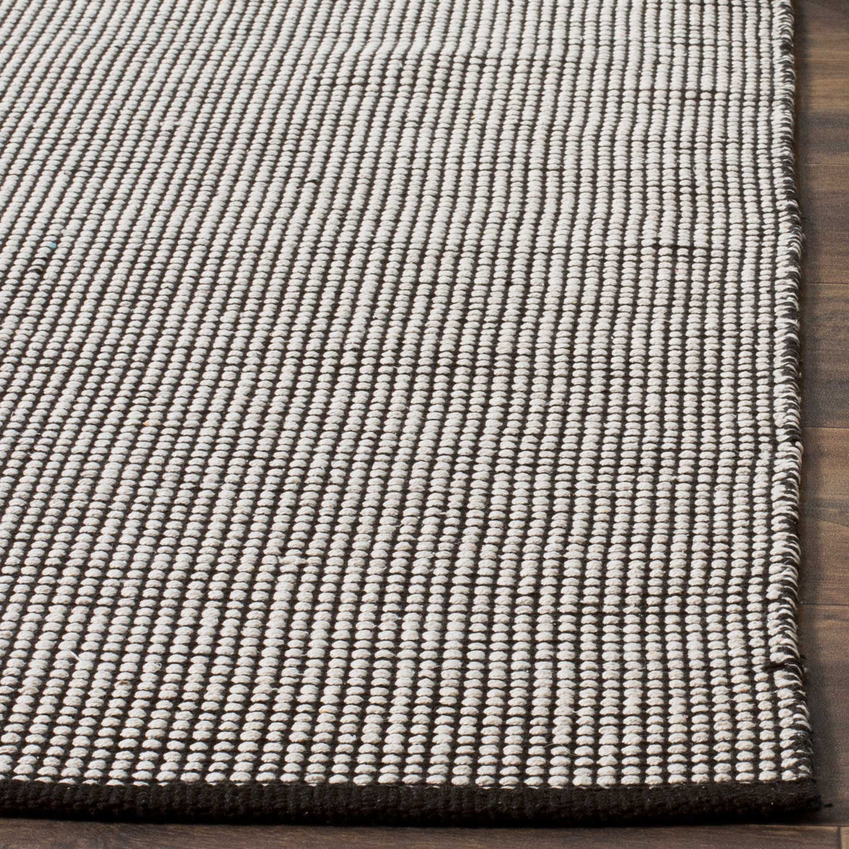 Tightly woven ivory stitches create a lively check texture above a dark border.