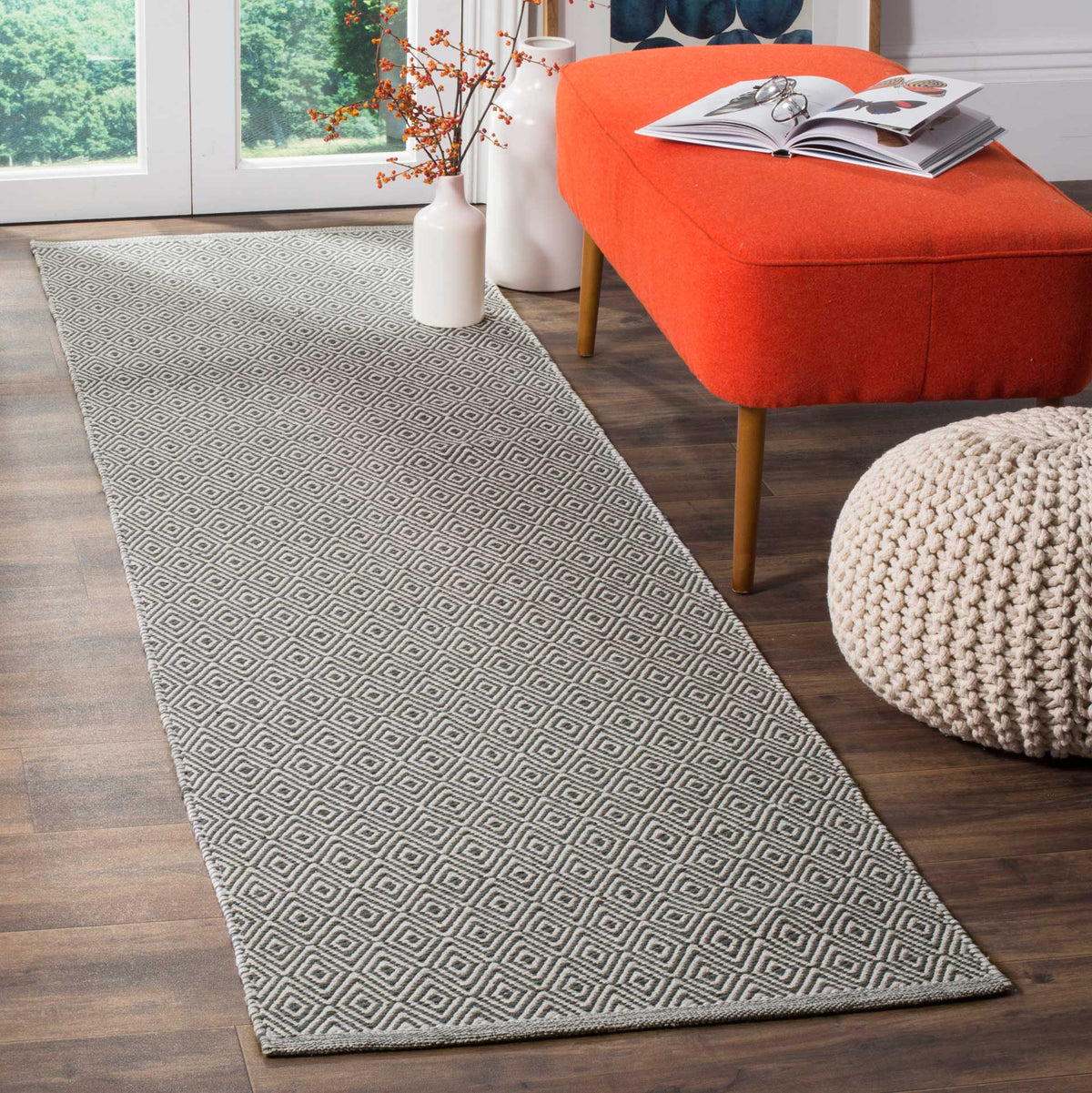 Graphic gray diamonds lend a clean, textured look to this ivory runner