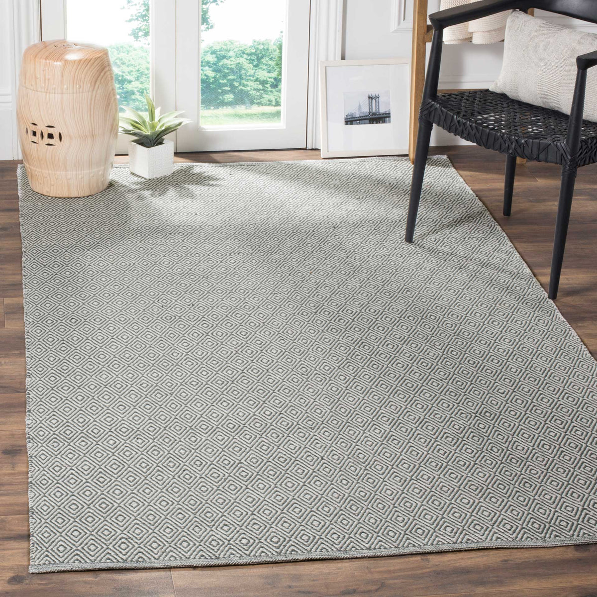 An ivory and gray diamond rug adds graphic texture beside living room seating